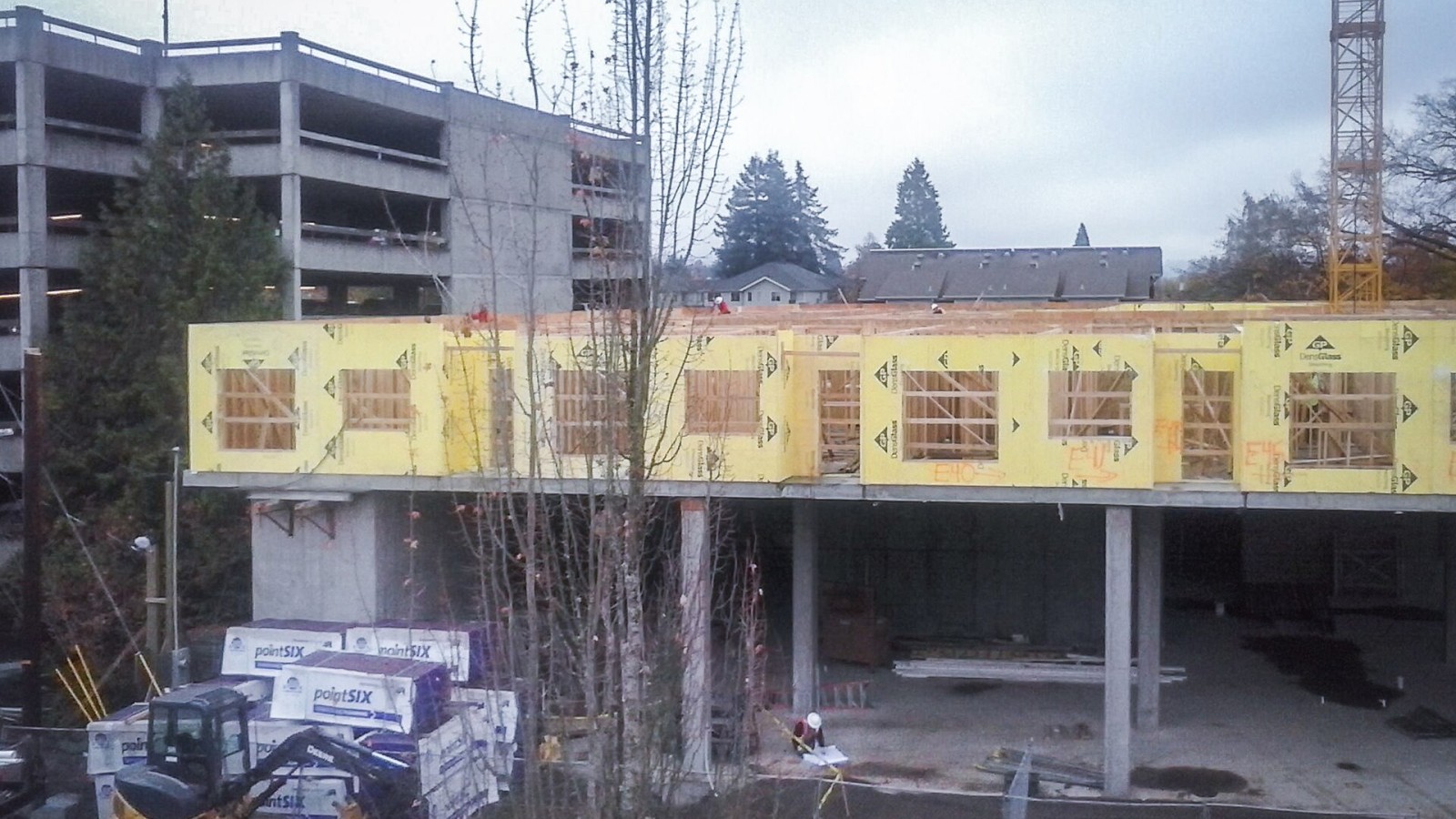 A contractor reads the blueprints at a construction site in Eugene, Oregon