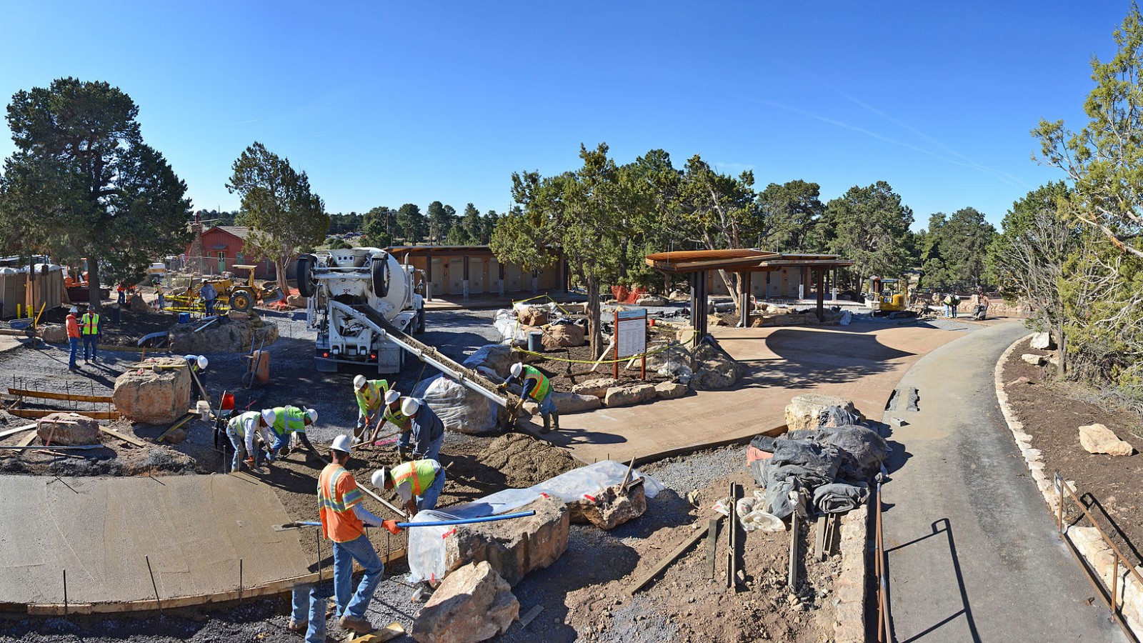 April, 24, 2013. With landscape boulders and stonework set in place, workers are now completing the pavement . This includes concrete portions of the trailhead plaza and the remaining footpaths. The overall project is on