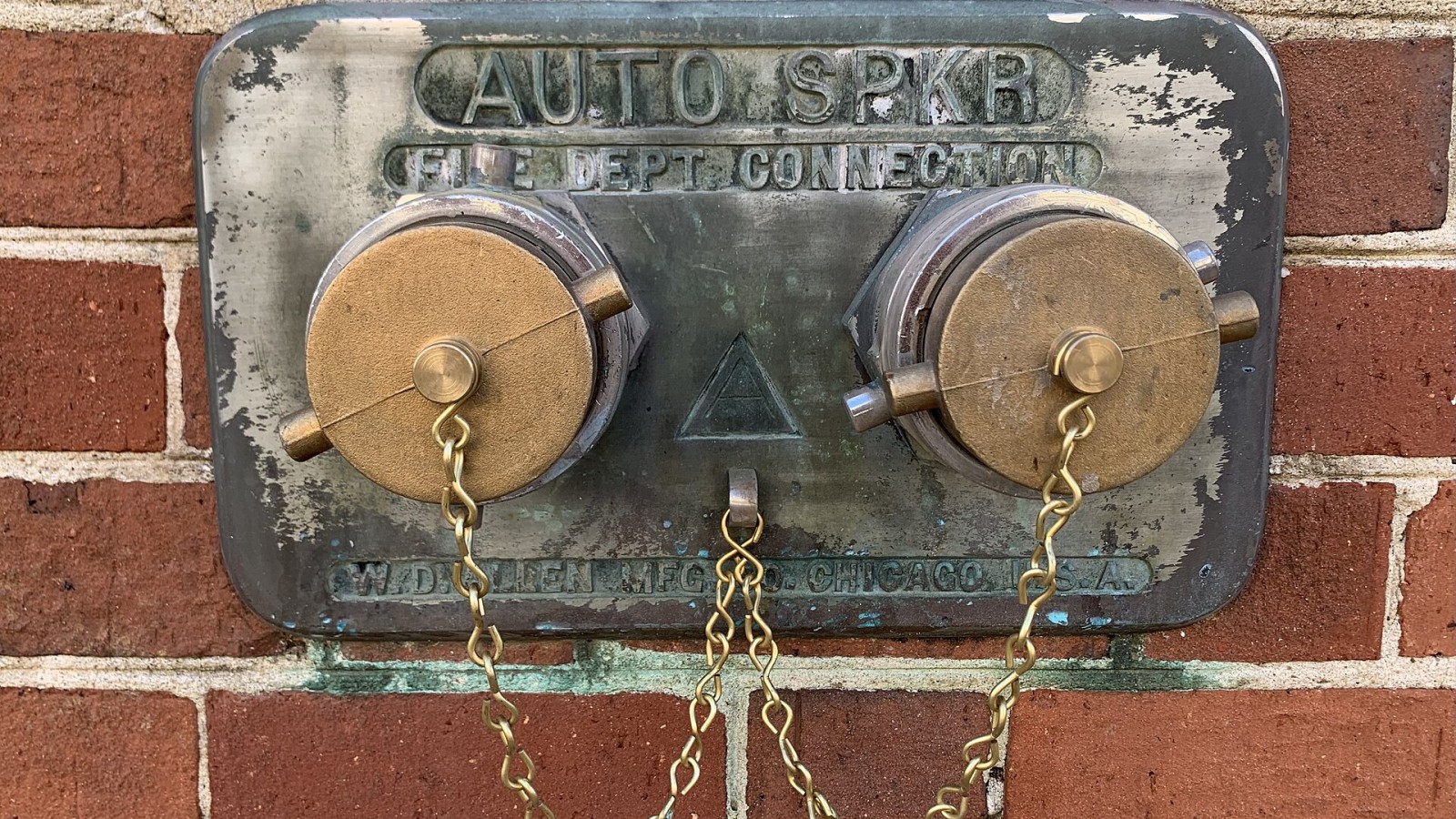 Fire department connection for an automatic sprinkler system, manufactured by W. D. Allen Manufacturing of Chicago, Illinois, on a building in Natchez, Mississippi.