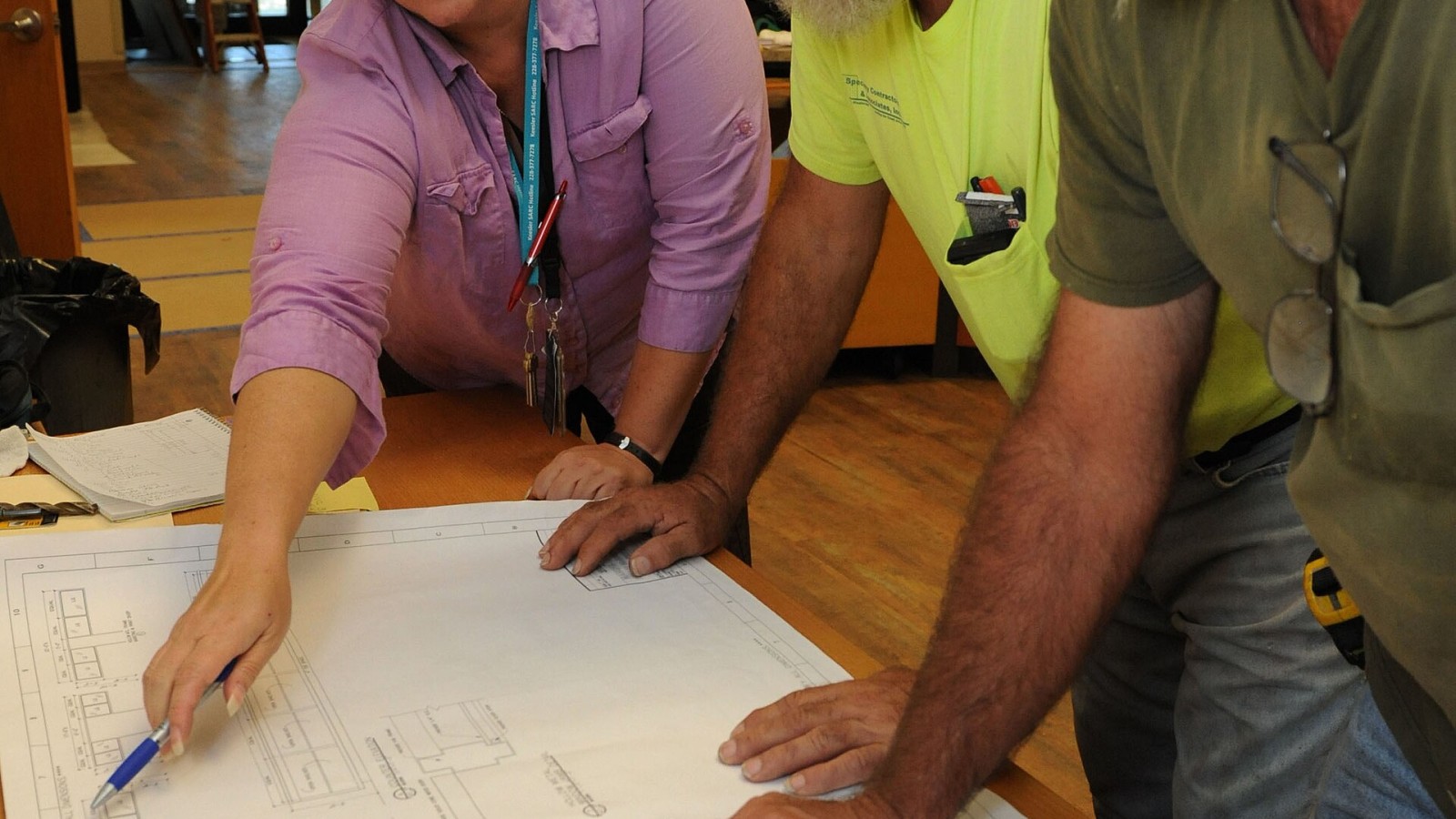 Michelle Bain, Base Operations facility space manager; Richard Taylor, Specialty Contractors and Associates, Inc. foreman; and Earl dean, DNP, Inc. superintendent , review construction documents at the McBride Commons Au