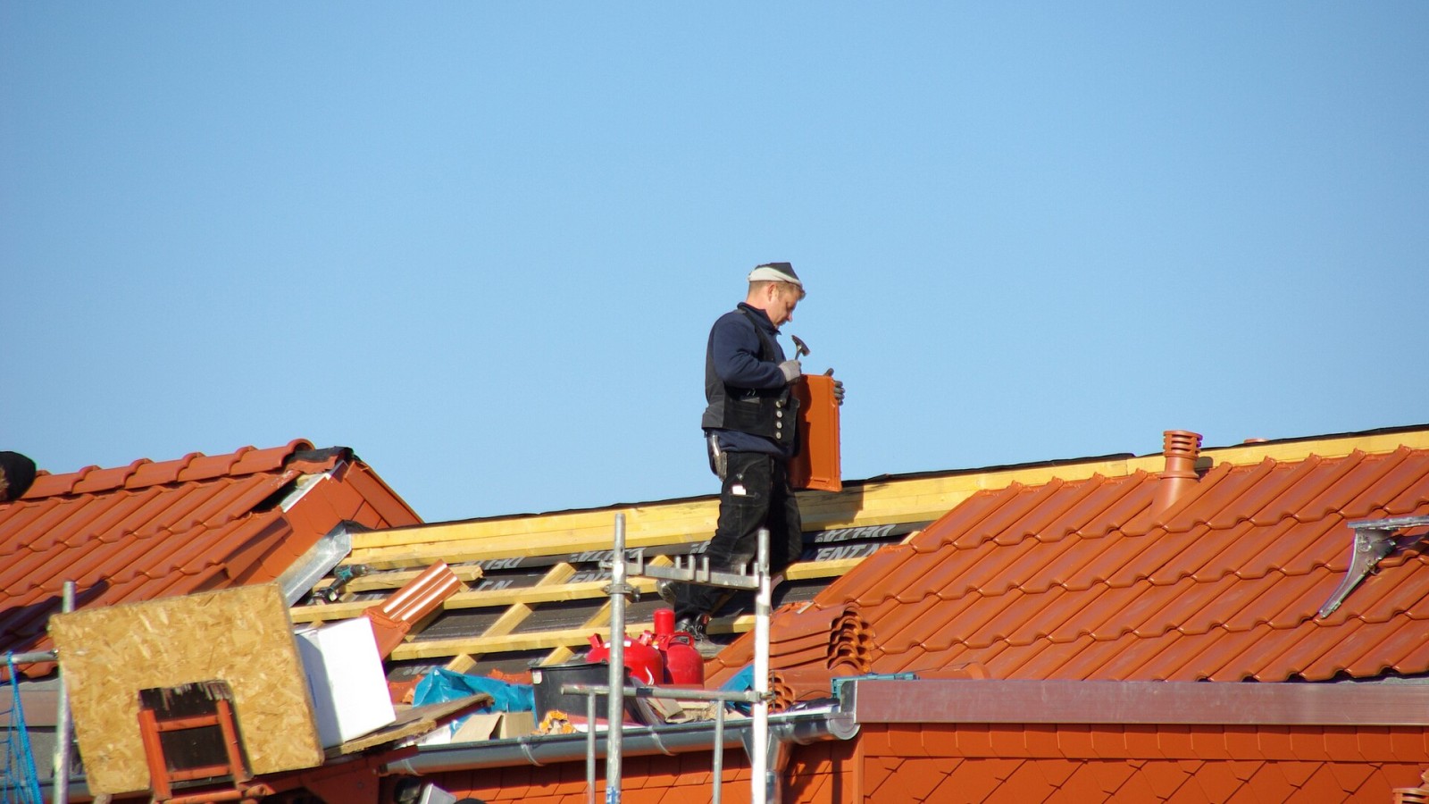 A carpenter working on a new roof in Rostock, Germany.