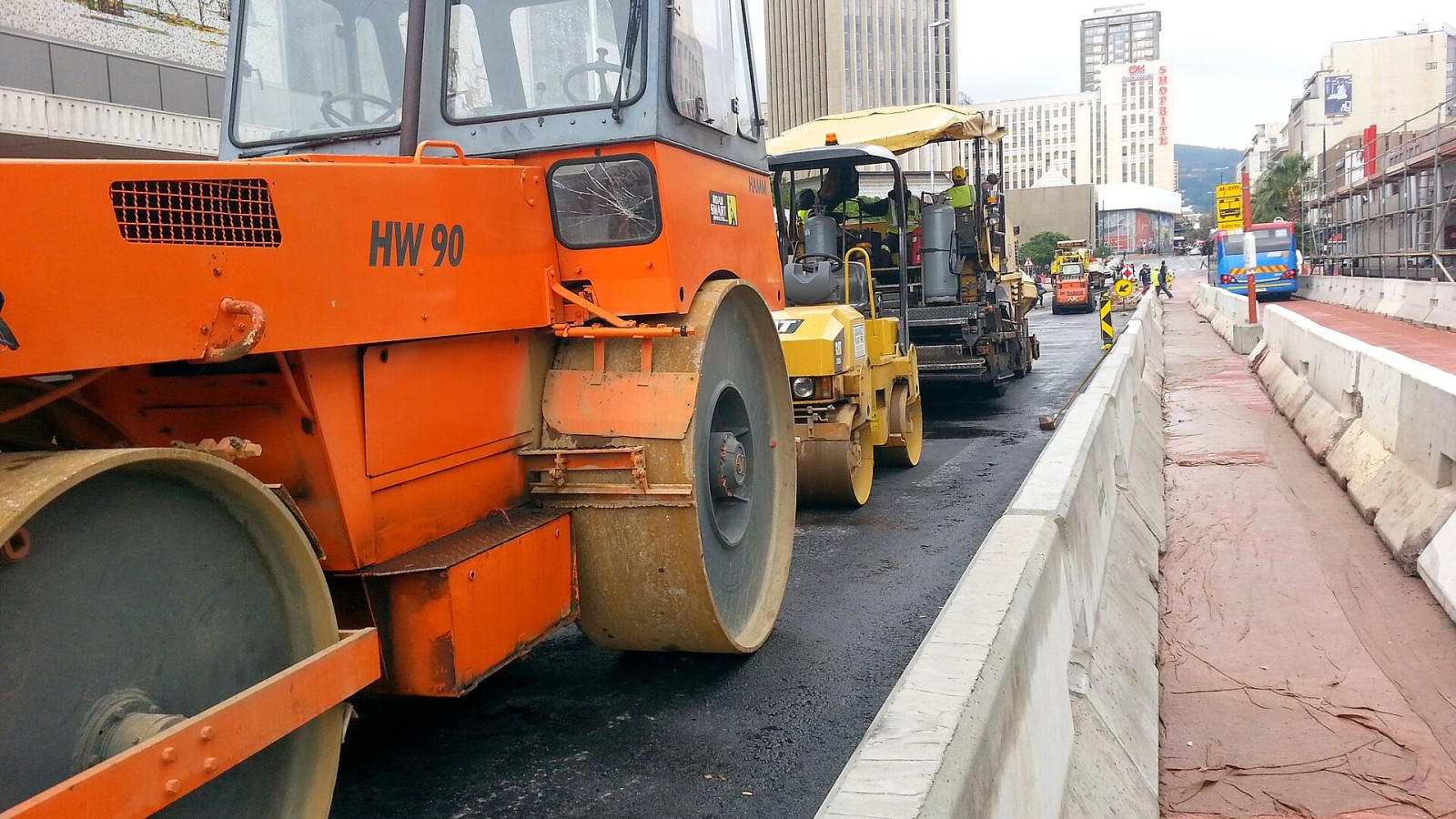 Road rollers and a paving crew working on a street in central Cape Town.