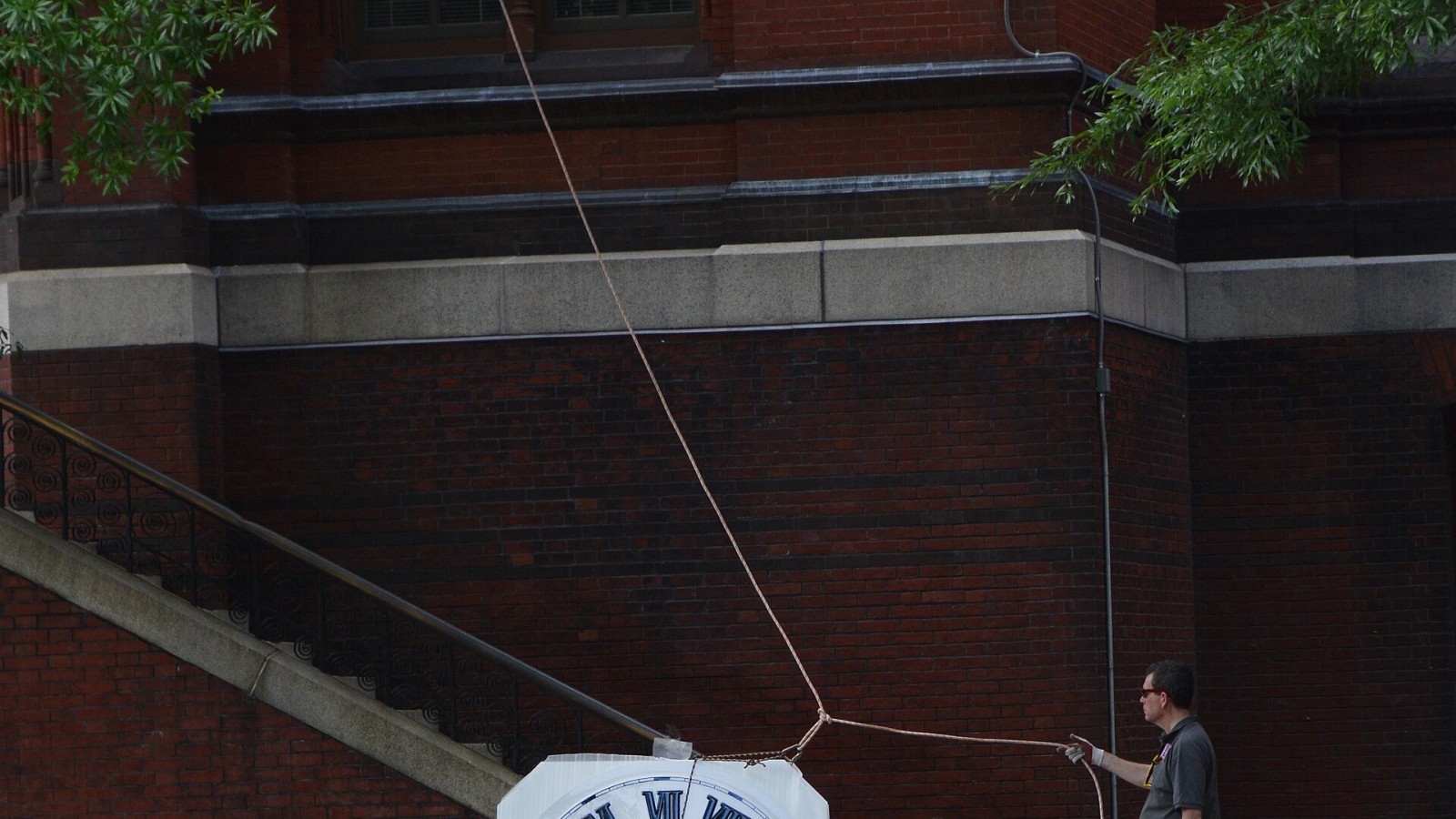 Workers prepare to install a clock as part of the renovation of the U.S. Department of Agriculture (USDA), Forest Service (FS), Yates Building in Washington, DC, on May 18, 2015. USDA photo by Dominic Cumberland.
