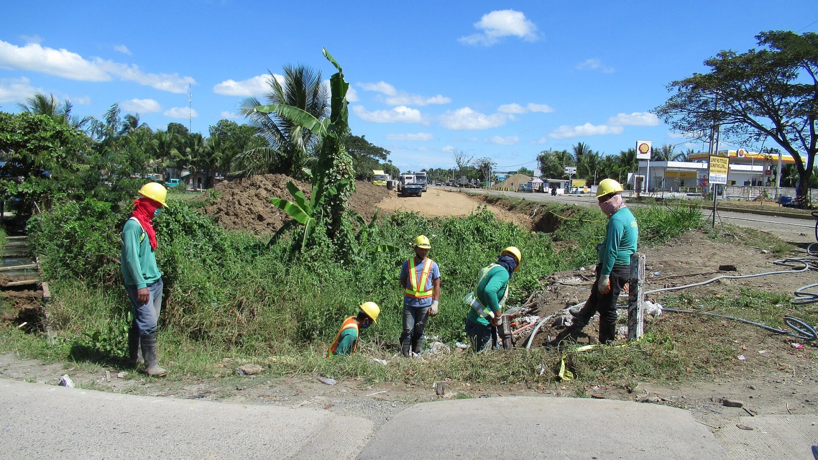 Bulakenyo stonemasons and construction workers (drilling) wearing helmets in road widening and rehabilition in the Arterial Road Bypass Project (Plaridel Bypass) Phase III, Contract Package IV) at Barangay Malamig, Busto