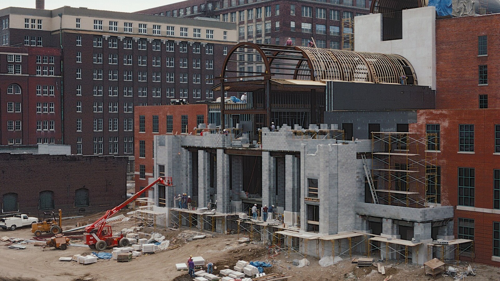Looking SE from approach to Clark Bridge. Presbyterian Church (U.S.A.) headquarters under construction. The building joins 2 former Belknap Hardware warehouses with a new connecting atrium. In the photo, workers are inst
