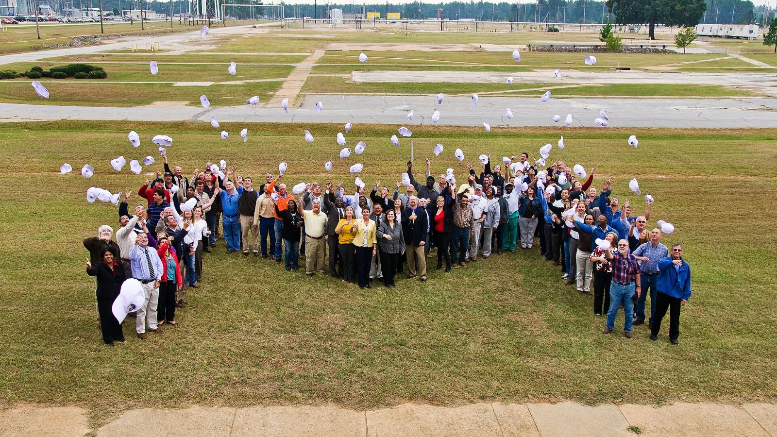 Ines Triay, DOE's Assistant Secretary of Environmental Management, celebrates the completion of M Area with SRS workers. (Ines is in the center of the M) Department of Energy, contractor and regulatory representatives ga