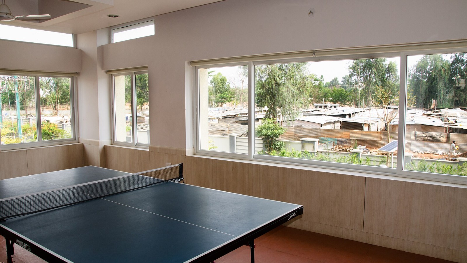 The gym of a gated community. In front are the makeshift houses of the construction workers. Workers and their families are living under bad conditions without bathrooms or schools for their children while building luxur