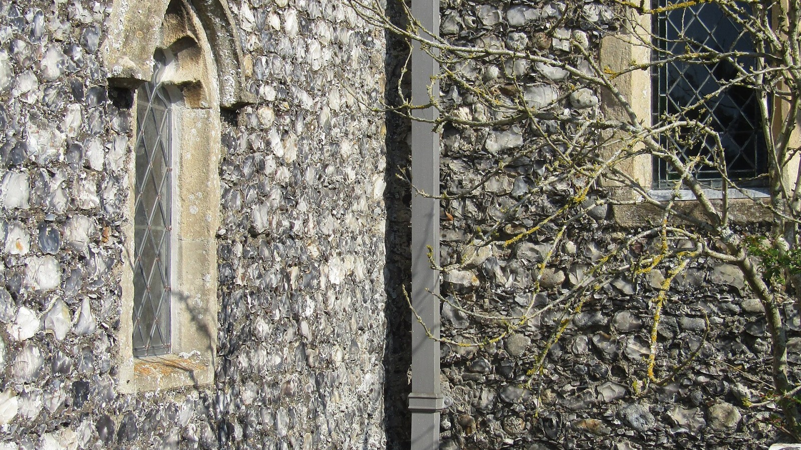 A gutter downpipe on the south elevation of Saint Mary's parish church in the village of Northrepps, Norfolk, England.