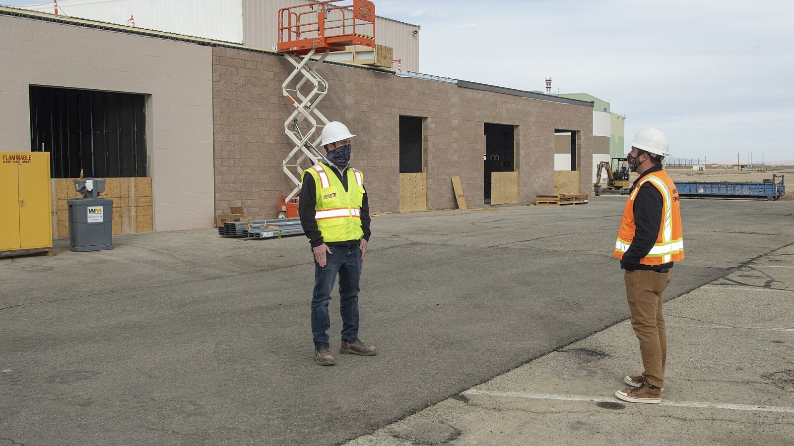 Collin Morris, CJW/MZT project manager and Bryan Watters, NASA civil/structural engineer and project manager, discuss work on the east side of Building 4826. Building 4826 is the future home of the X-59 Quiet SuperSonic