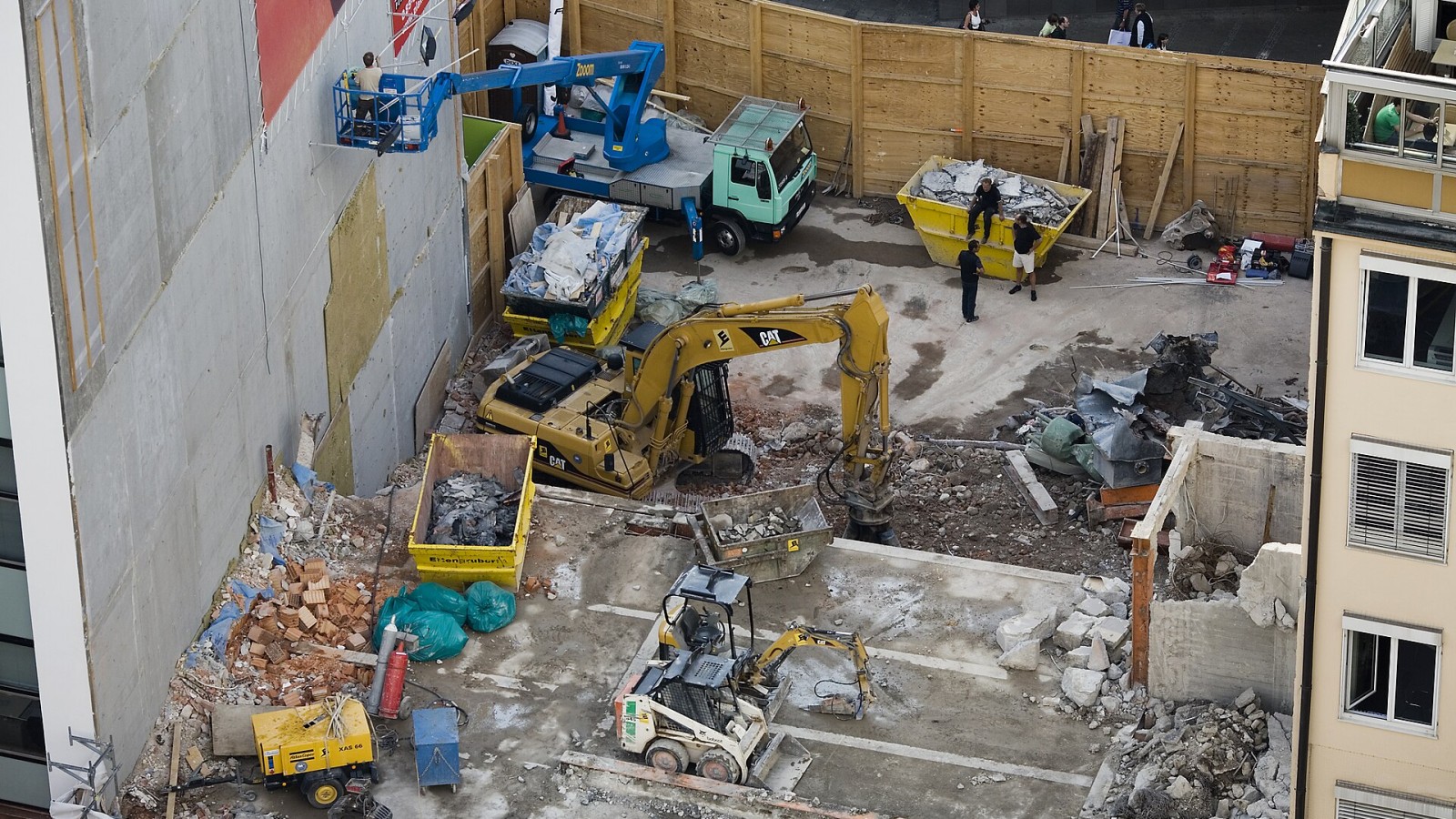 View of a demolition site and beginning of a new building with bulldozers. Munich, Germany