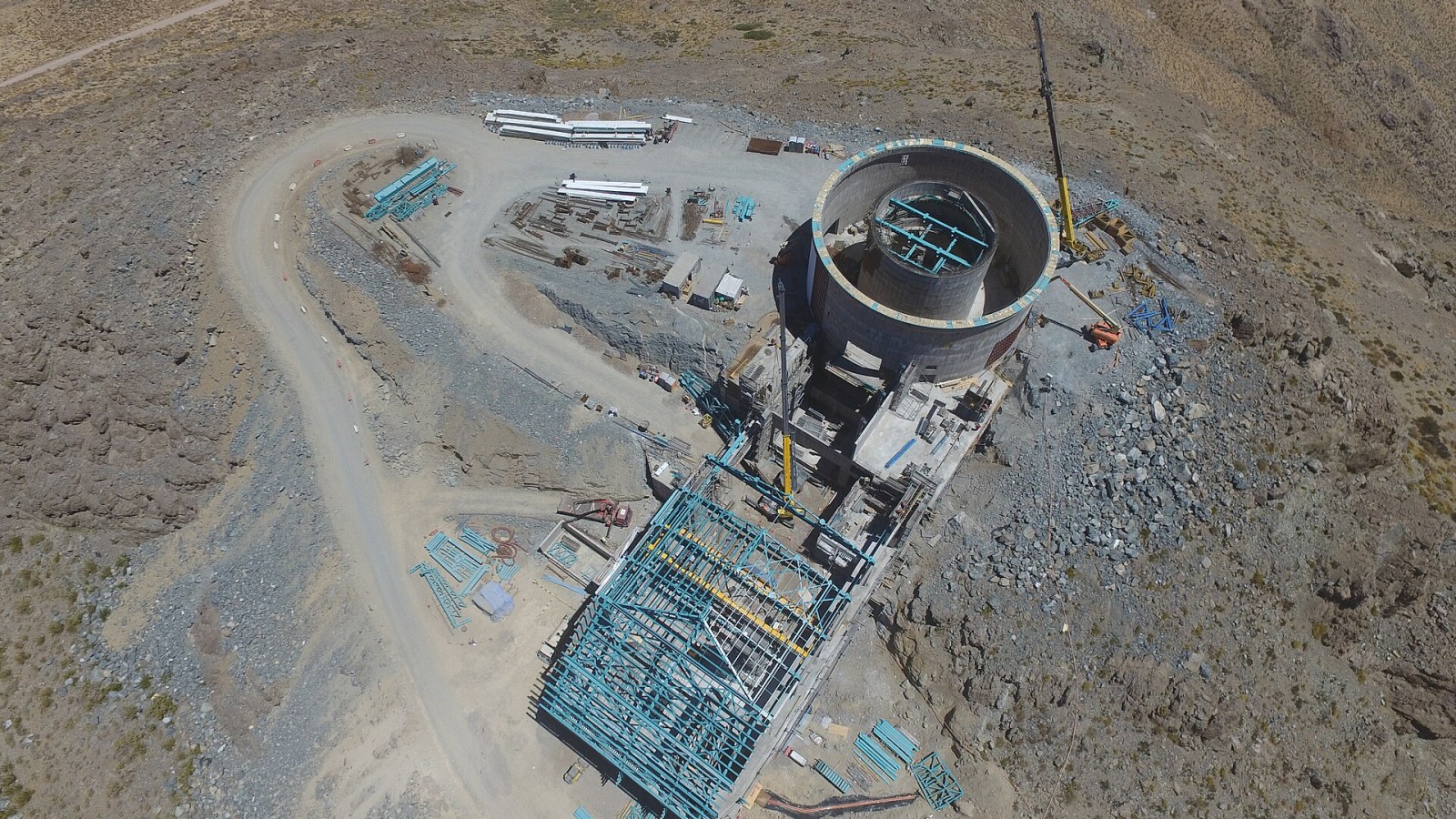 This aerial photo, taken by drone, shows the elevator shaft, lower enclosure with the pier inside, and the (long, rectangular) service building.