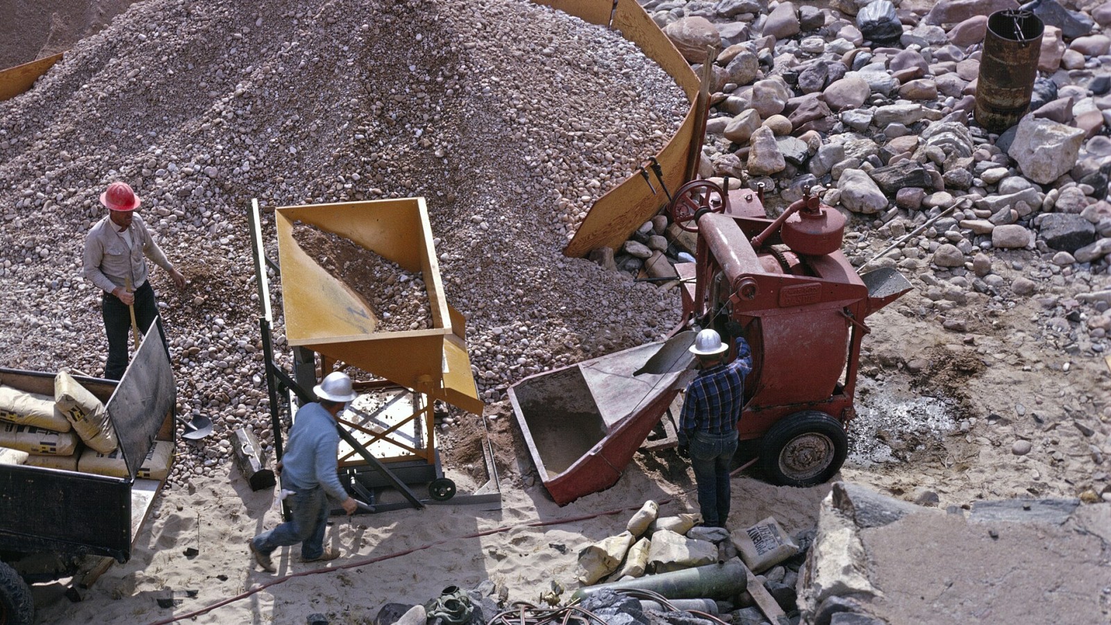 Mixing concrete during construction of cable anchors for Silver Bridge across the Colorado River, 1965. NPS Photo by Dan Cockrum. GRCA 81008