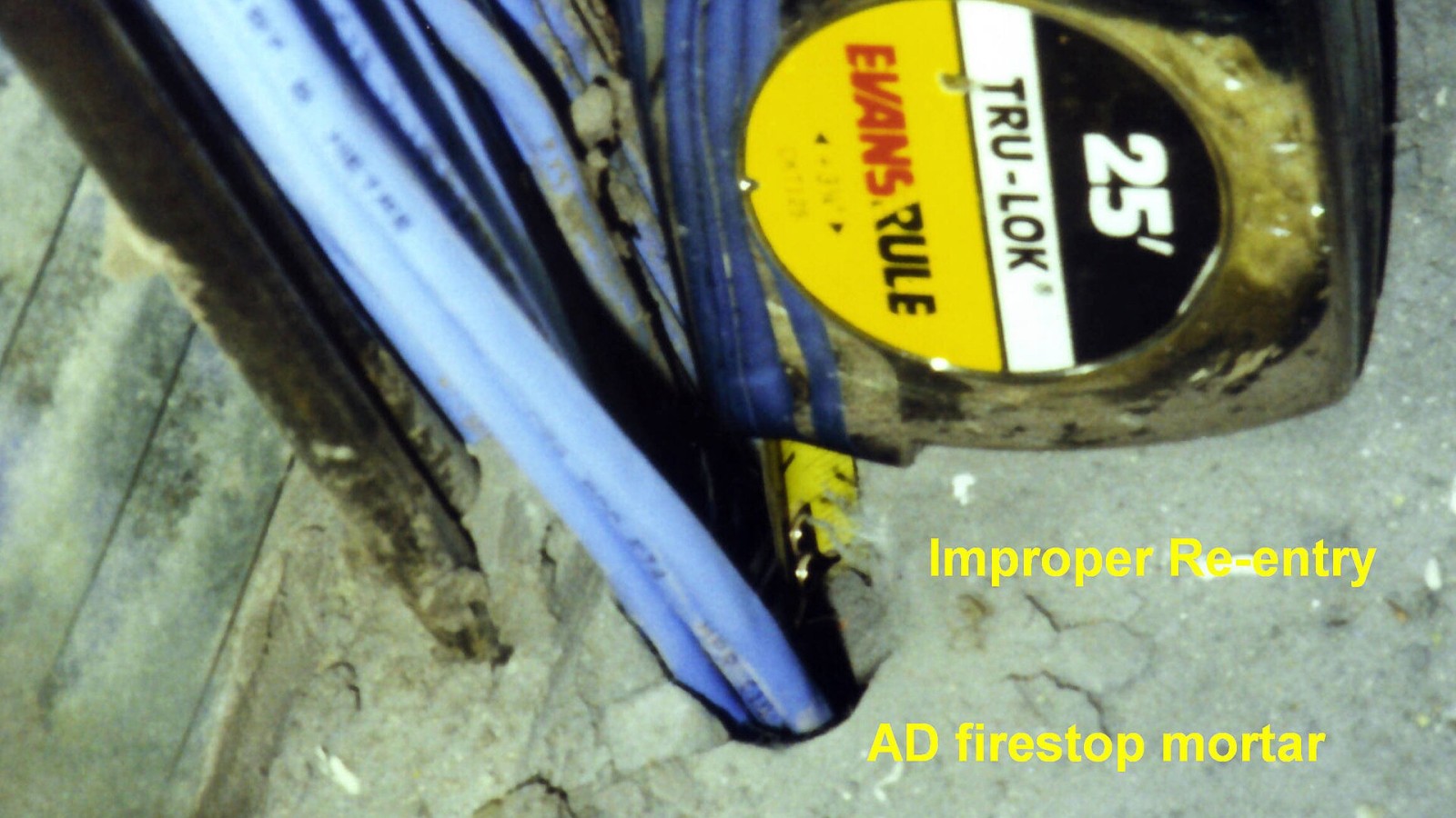 Canadian Broadcasting Corporation, Toronto, Ontario, Canada, Electrical Closet: During the original construction, AD firestop mortar was installed at insufficient depth in this cable tray penetration. Re-entries were not