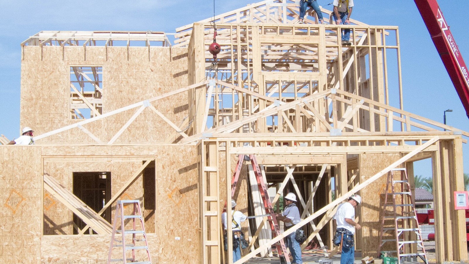 Residential construction workers use a fall arrest system