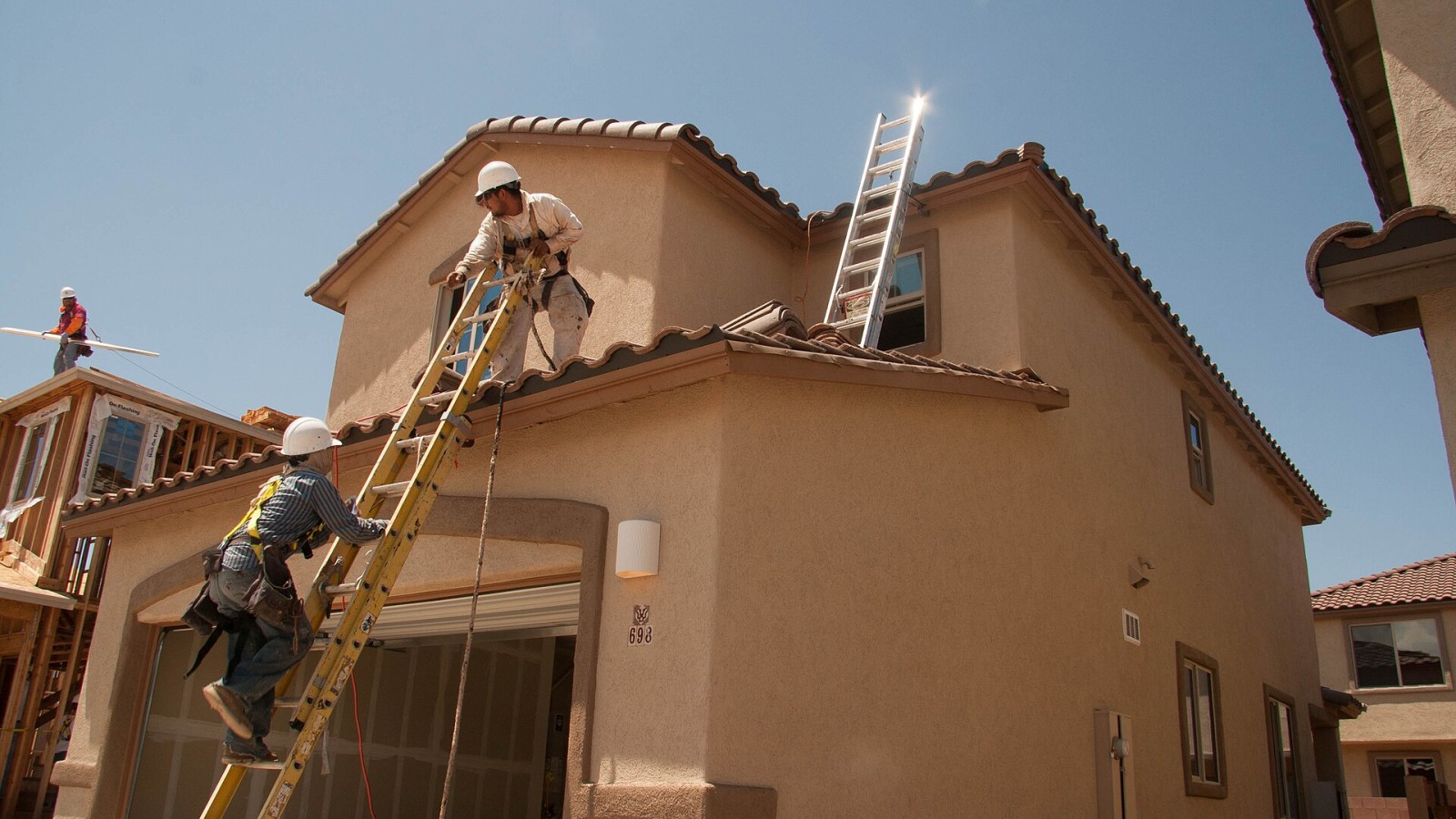 A residential construction site using fall arrest systems