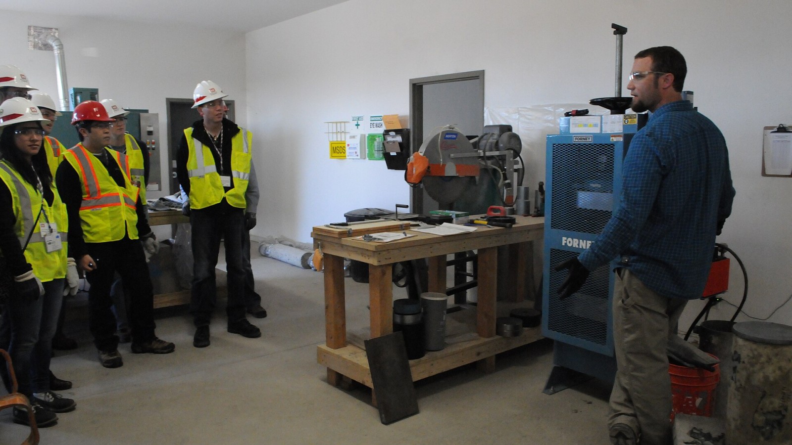 Tim Goetz, a lab technician for the Folsom Dam spillway project, tests concrete core samples under extreme hydraulic pressure Jan. 26, 2013 during a demonstration to recent college graduates from the American Society of