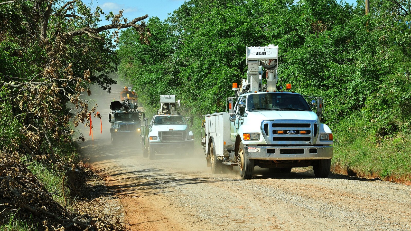 Cleveland County, OK, May 20, 2010 -- An Oklahoma Electrical Cooperative line crew travels down a rural road on its way to repair electrical infrastructure in a section of the county struck by a tornado on May 10. The ea