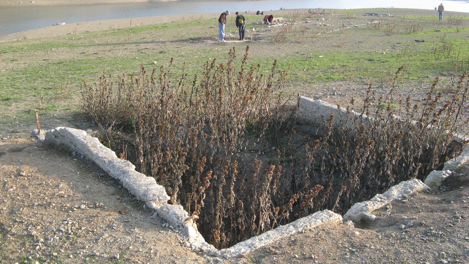 Foundation of home in Lexington, normally covered by the water of Lexington Reservoir, but exposed by dam maintenance. With a view in the background of the receded water.
