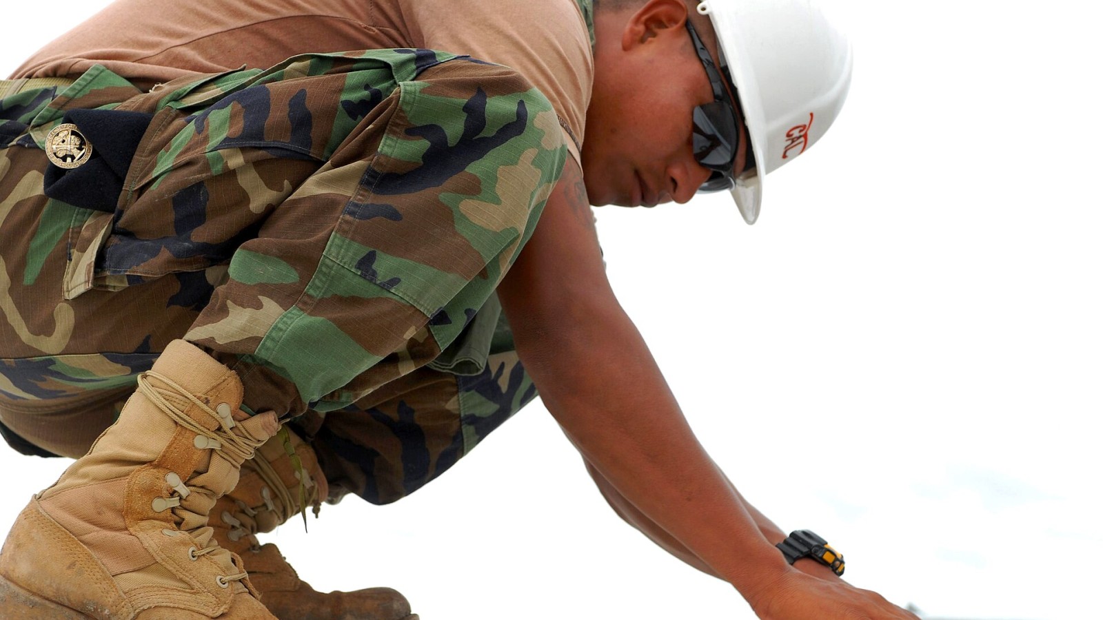 Belize Defense Force Lance Cpl. Domingo Cal makes minor repairs to the roof of a school construction project, Upper Poteau, Haiti, June 1, 2011.