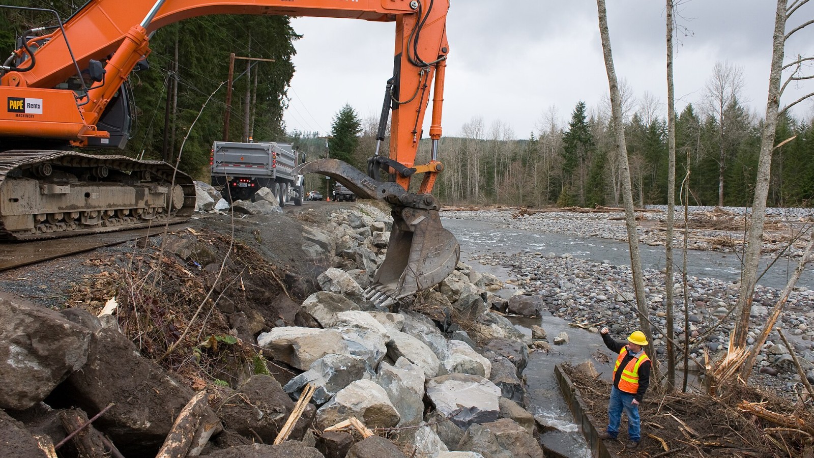 Orting, WA, February 9, 2009 -- Pierce County surface water crews repair a salmon ladder with "six man" rocks. The salmon ladder and roadway were damaged after recent flooding from the Carbon river due to torrential rain
