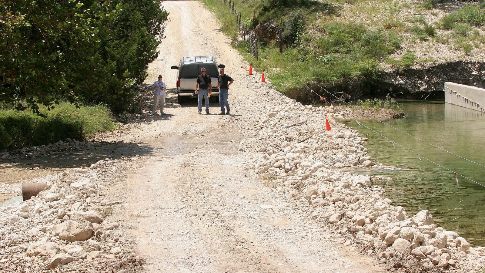 Leakey, TX, August 8, 2007 -- FEAM Public Assistanance Specialist Philip Brown and County Commissioner Manuel Rubio inspect damage to local infrastructure from the recent flooding to determine if Real County will be elig