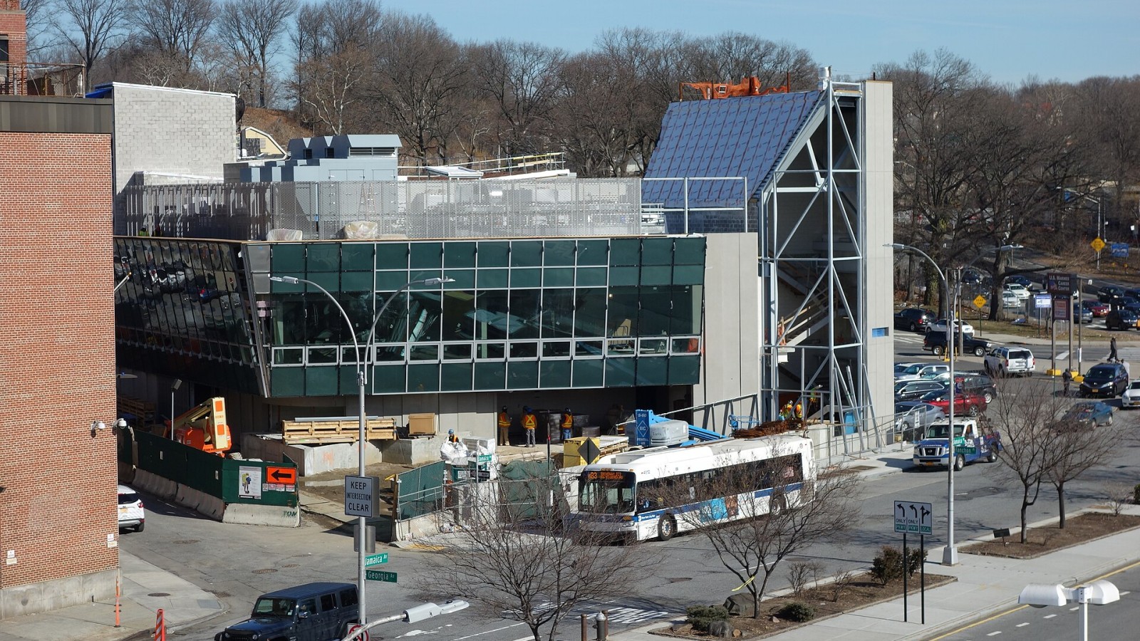 Looking at the new East New York Bus Command Center under construction at Jamaica Avenue and Fanchon Place in East New York / Broadway Junction, Brooklyn. A Broadway Junction-bound B83 bus is stopped in front of the buil