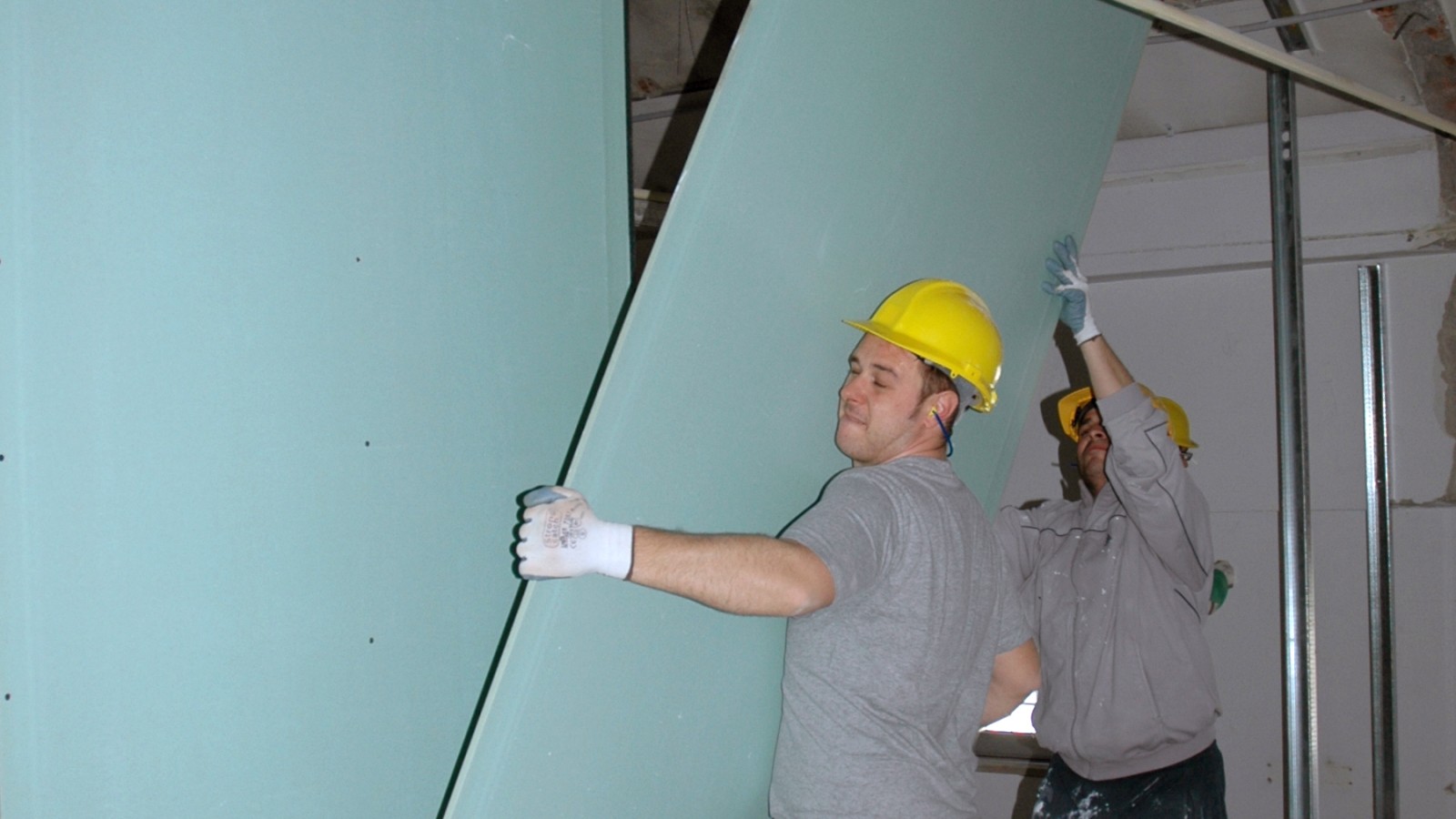 Workers put up interior walls as part of a renovation project for Building 28 at Caserme Ederle in Vicenza, Italy. The work includes replacement of walls, doors, windows, flooring, mechanical systems, and electrical and