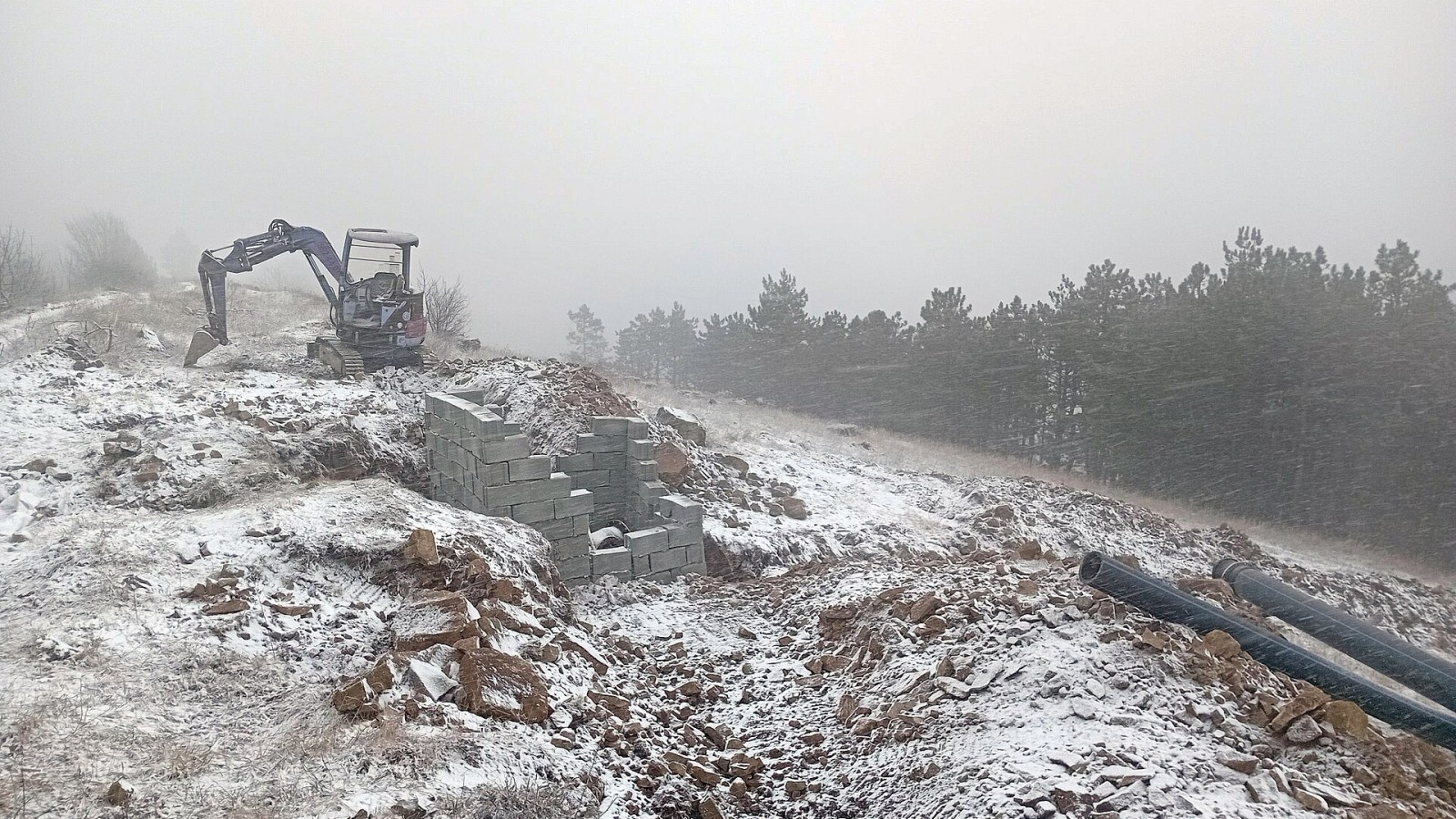 Pipeline construction east of the water pump station in Mtatsminda Range during a blizzard