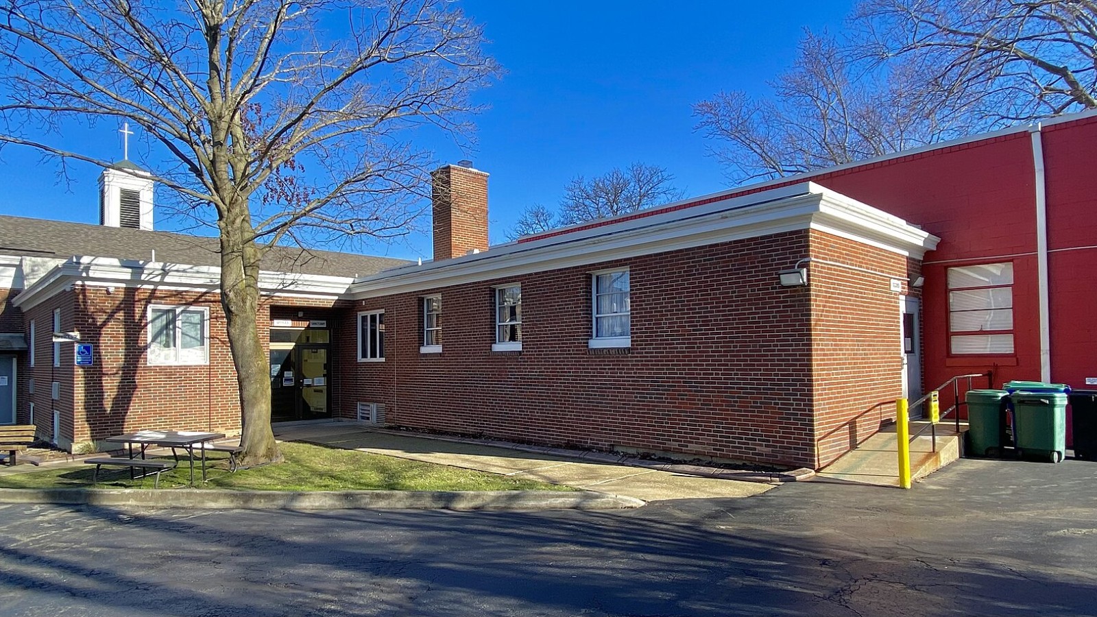 As seen on an April 2023 afternoon, the office facilities and rear entrance of the First Congregational United Church of Christ in Angola, New York were among the portions of the building complex constructed in 1970, two