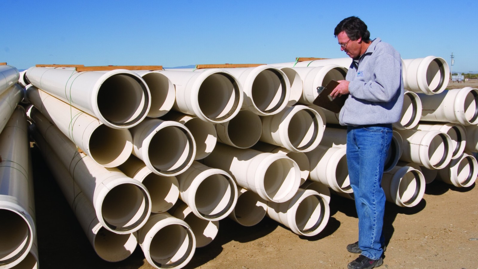 An NRCS engineer inspects plastic pipe prior to construction of an NRCS funded EQIP project. Photo by Jeff Vanuga/USDA-NRCS.