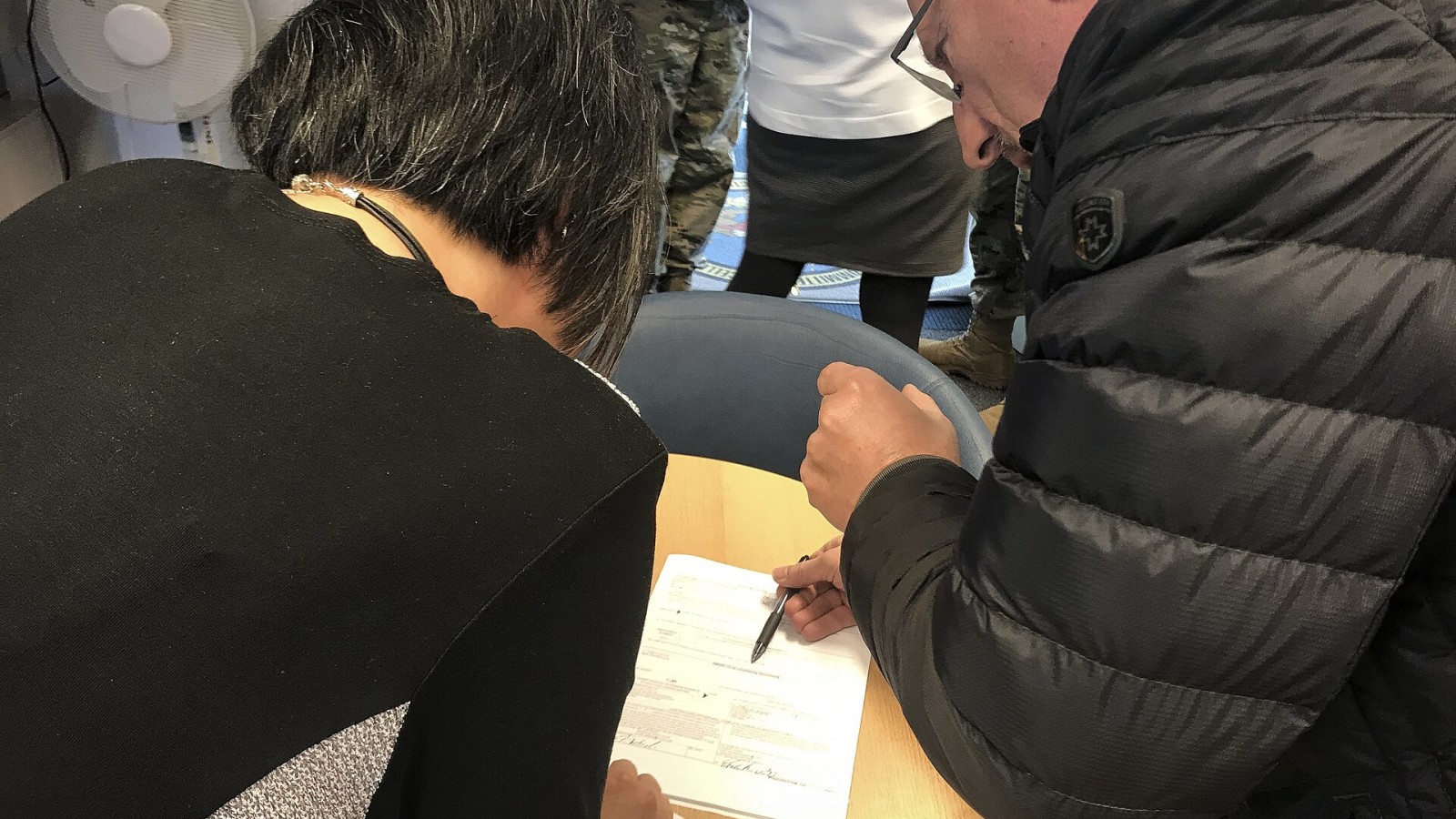 Elizabeth Preston, left, 700th Contracting Squadron construction flight team lead, and Peter Dietrich, S.K.Horn contractor, sign a copy of the most substantial contract the squadron has ever produced on Kapaun Air Statio