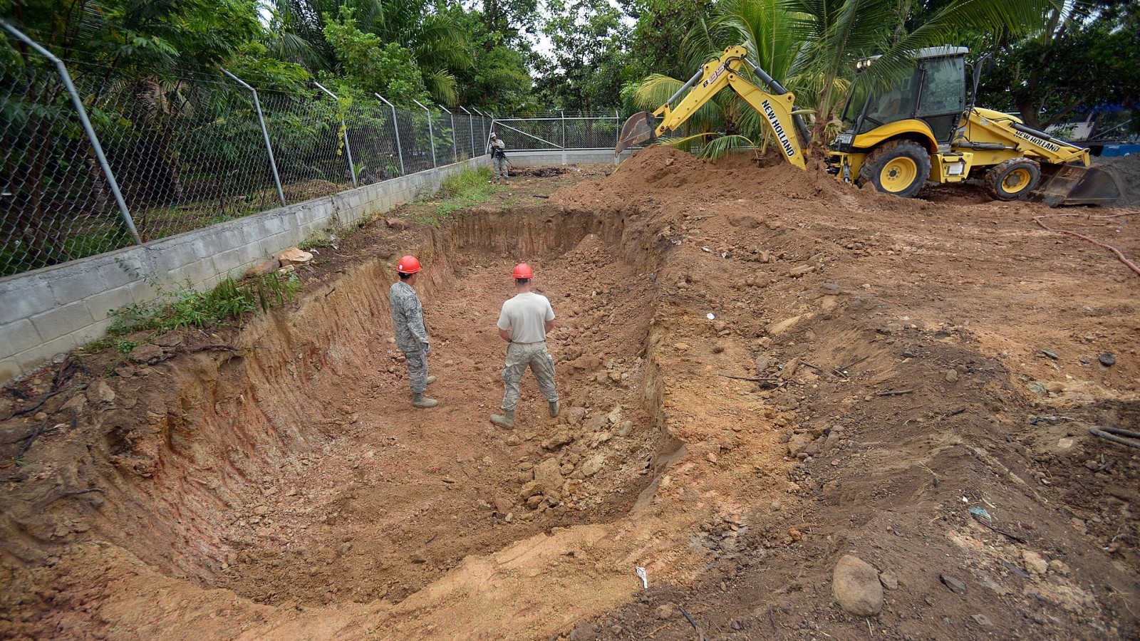 Members of the 823rd Expeditionary RED HORSE Squadron, out of Hurlburt Field, Fla., access a hold dug for a septic take at the Gabriela Mistral primary school in Ocotes Alto, Honduras, June 3, 2015. The construction proj