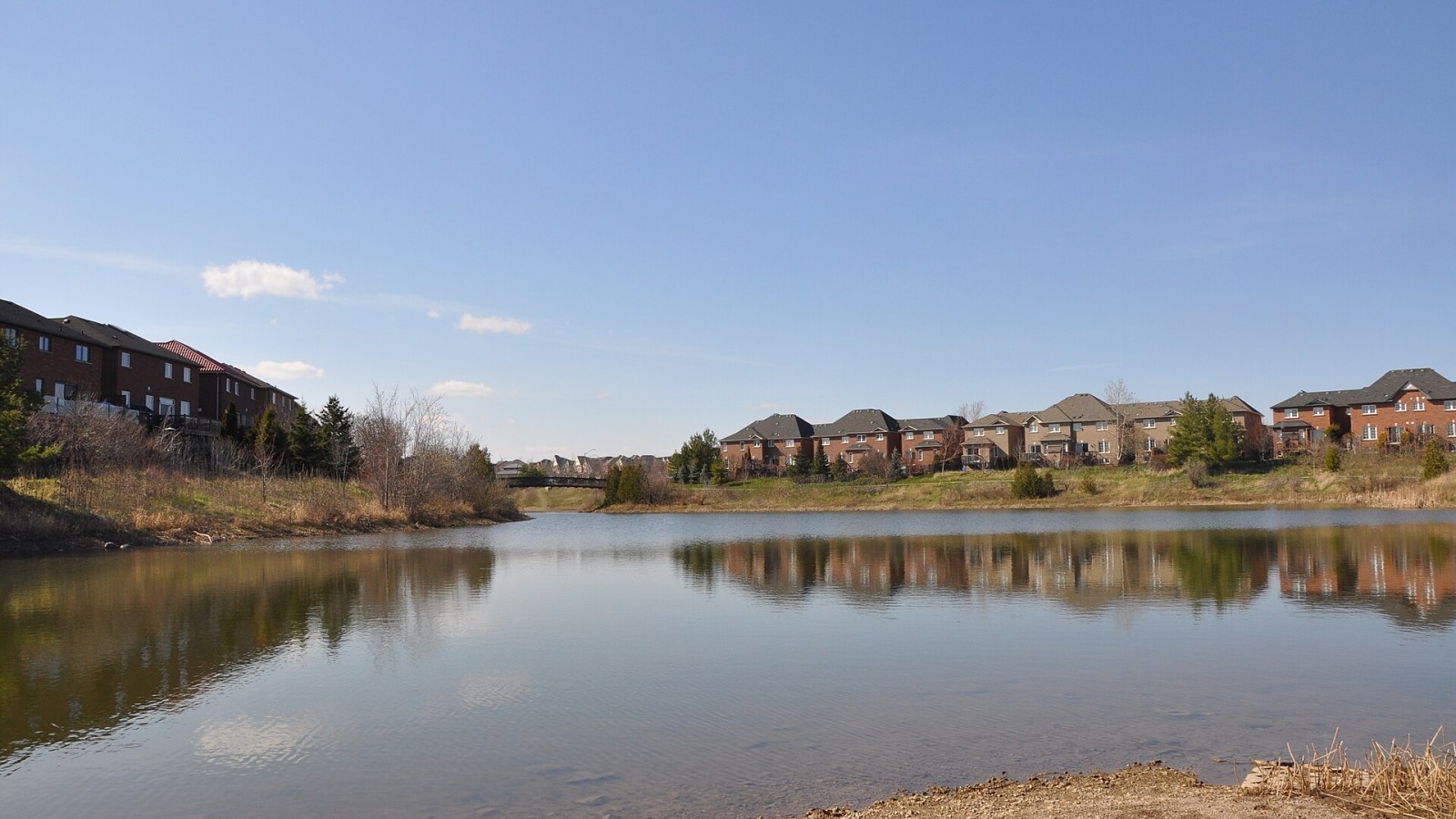 Retention pond used for stormwater management in northwest Oakville, ON residential area and adjacent park