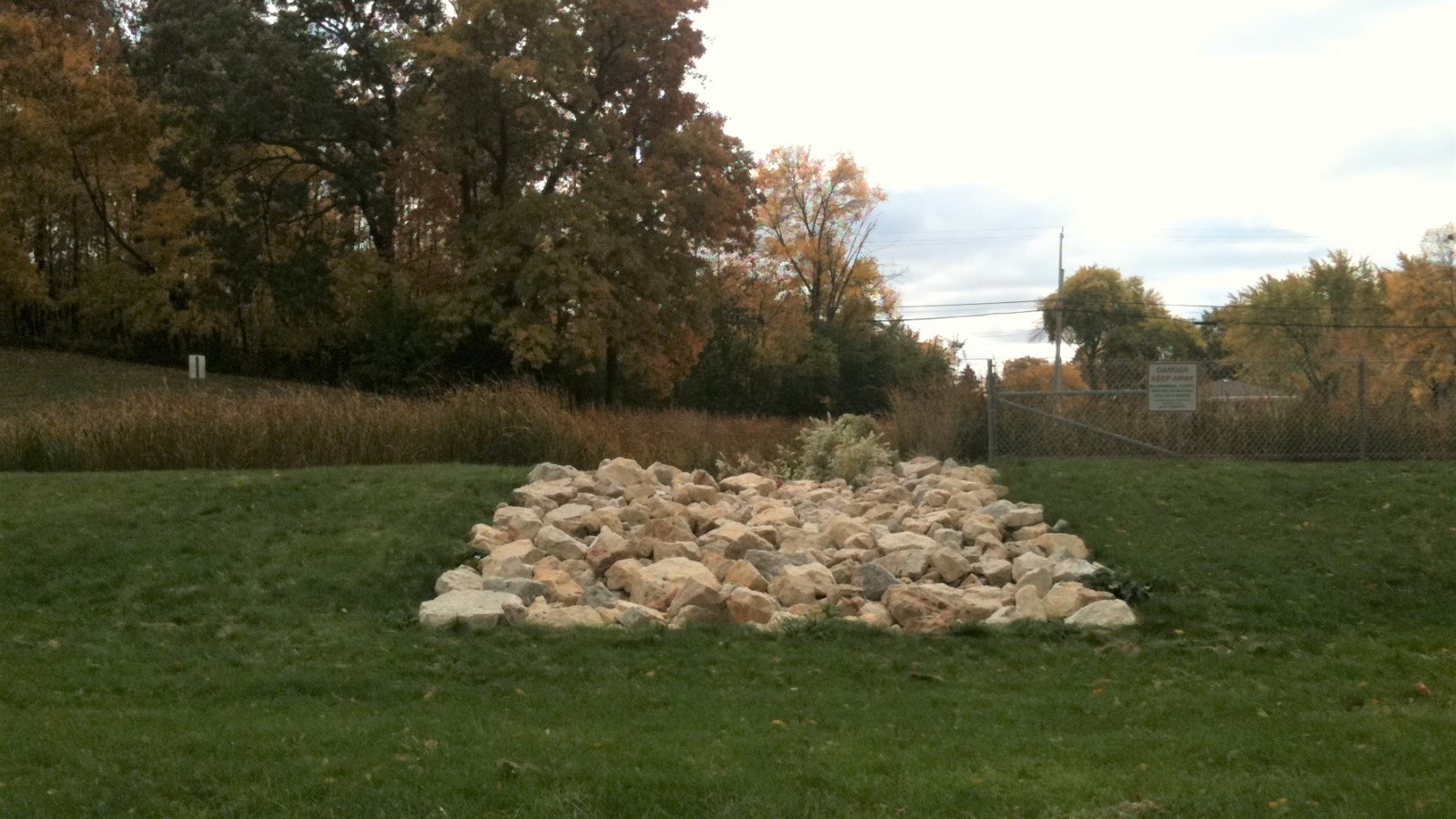 Riprap overflow spillway / emergency spillway from a stormwater detention pond in Greendale, Wisconsin. Located in College Park, north of College Avenue. Built in 2010 as part of Milwaukee County's College Avenue road re