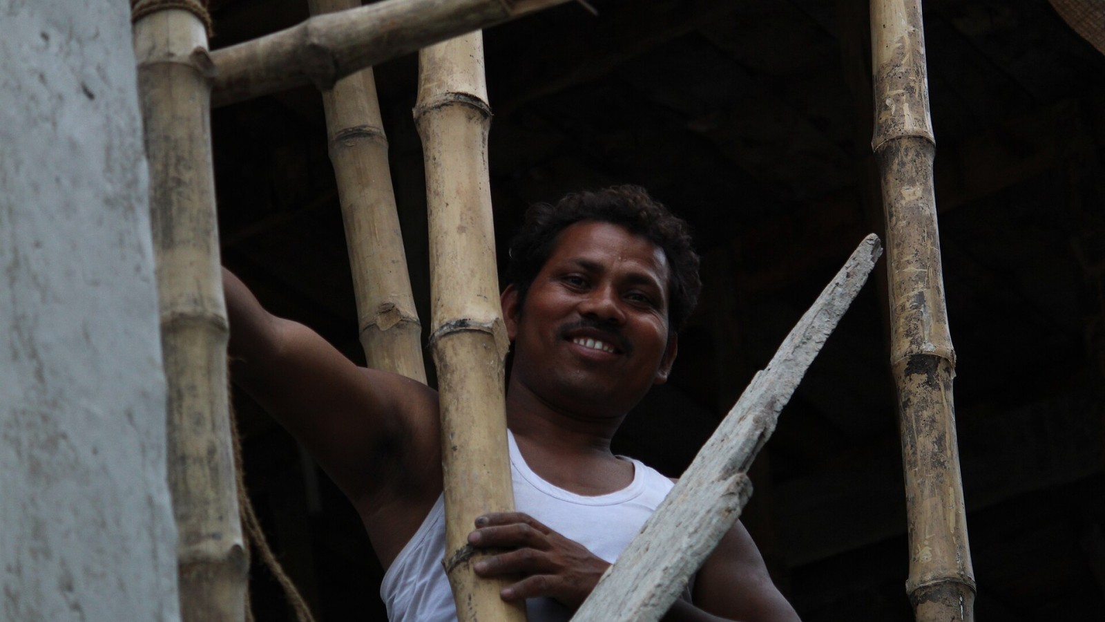 An Indian Male labour working at a building construction area.